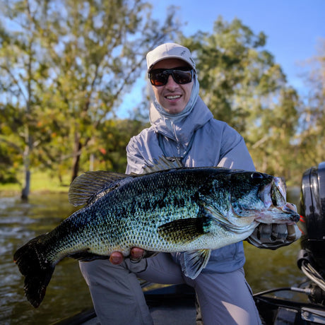 Sportfiskare håller en stor fisk vid vattnet i Extremadura i Spanien